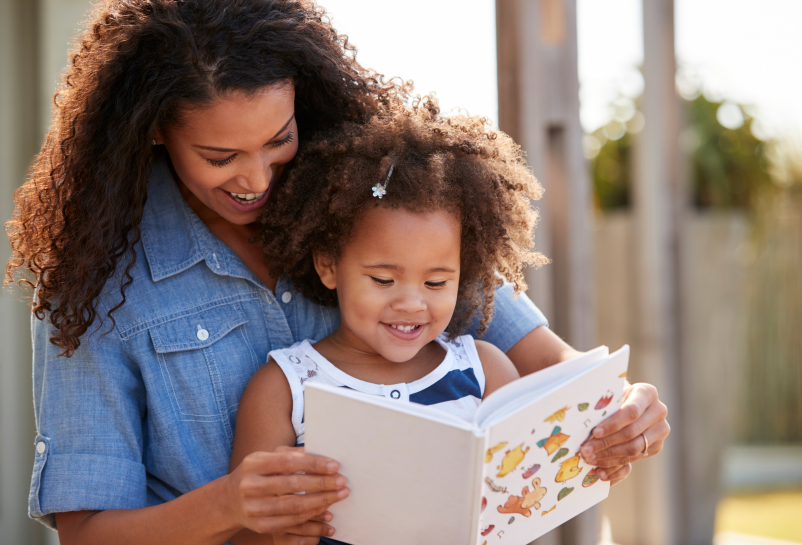 woman and child reading a book