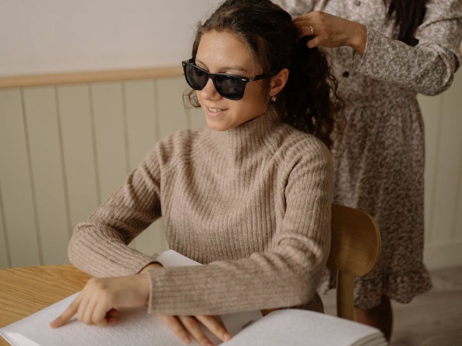 person reading a braille book