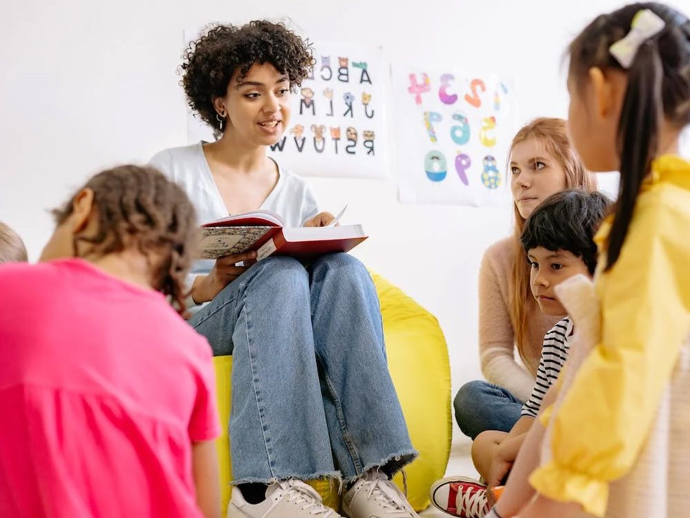 woman with book and young people