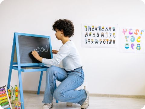 person writing on a chalk board